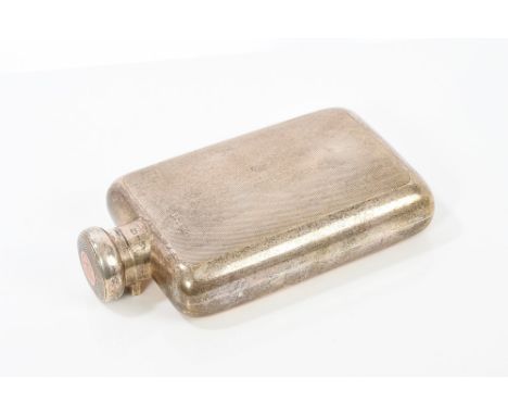 1920s silver spirit flask of rectangular form, with engine-turned decoration and hinged bayonet fitting cover with gold inser