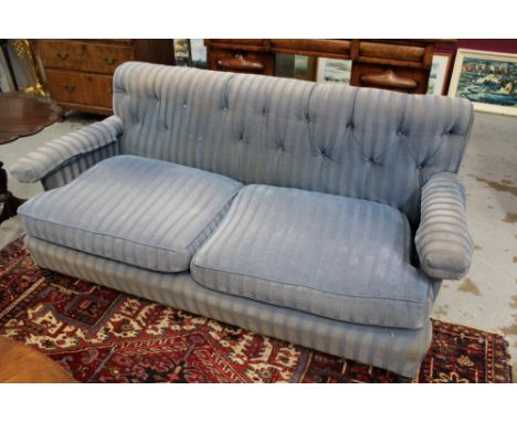 Victorian twin seater sofa with button upholstered back and square arms, raised on turned legs and castors in blue striped up