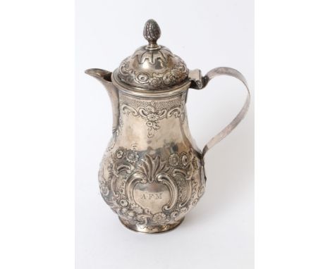 Late 18th century Irish silver coffee pot of baluster form, with strap handle and hinged domed cover, engraved armorial crest