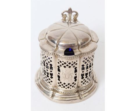 Victorian silver mustard pot of shaped octagonal form, with panels of pierced decoration, scroll handle and domed hinged cove