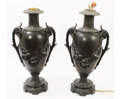 Pair of early 20th century Continental spelter lamp bases of slender urn form, with fluted neck and twin scroll handles issui