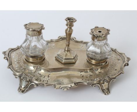 Victorian silver desk stand of shaped oval form, with engraved presentation inscription, pierced decoration and scroll border