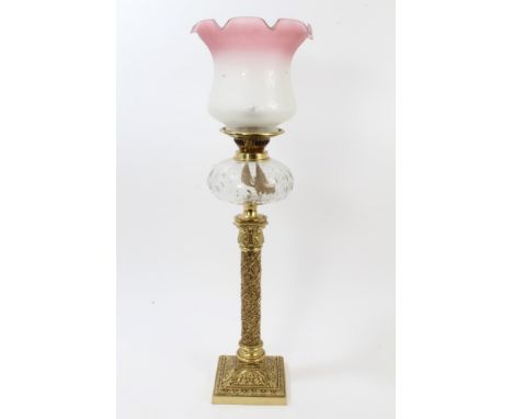 Ornate late 19th century oil lamp with bulbous-form pink etched glass shade and cut glass reservoir, on ornate pierced brass 