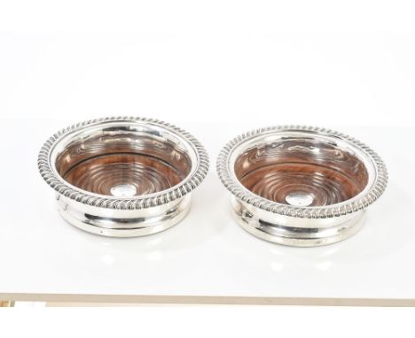 Pair early Victorian silver wine coasters of circular form, with gadrooned borders and turned wooden bases with central silve