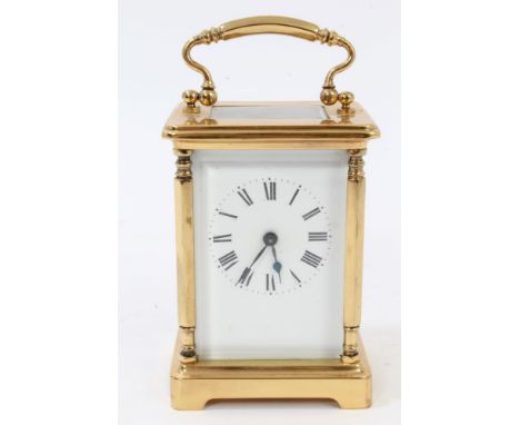 Contemporary brass carriage clock with white enamel dial and brass swing handle, 15cm high (key present)