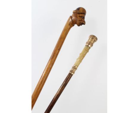 Victorian carved hardwood novelty walking stick, the terminal carved with the head of a man wearing a cap, with inset glass e