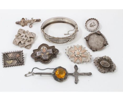 Collection of nine Victorian and later silver brooches and a Victorian silver hinged bangle