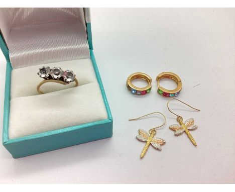 A Three Stone Crossover Ring, the circular claw set stones within crossover style setting, to uniform slim band stamped "9ct 