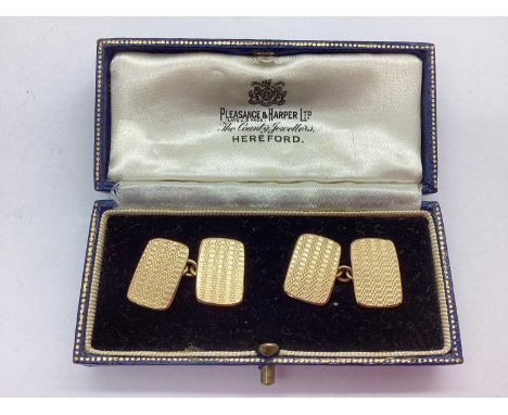 A Pair of 9ct Gold Gent's Cufflinks, the rectangular shaped panels of engine turned design, on chain link connections, stampe
