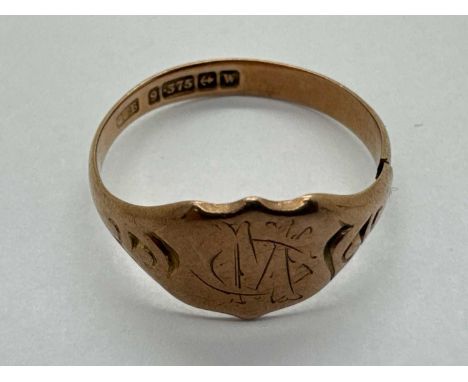 A 9ct Gold Signet Ring, the centre panel of shield form, monogrammed "CM", between tapered shoulders with scroll decoration, 