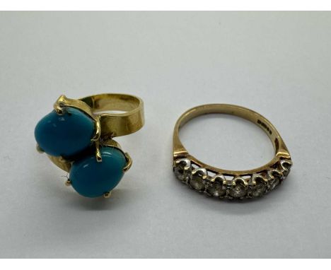 A Two Stone Crossover Ring, the oval cabochon stones four claw set to crossover setting, between uniform band (stamped indist