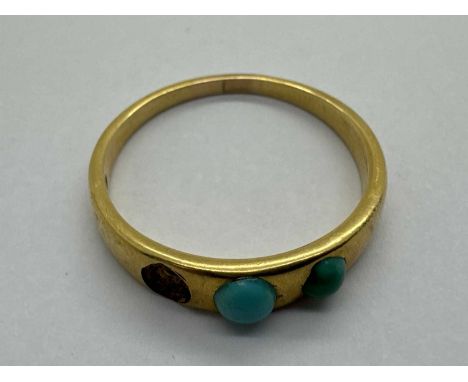 An Antique Three Stone Turquoise Set Ring, (one stone missing), the collet set stones of graduated size, between tapering ban