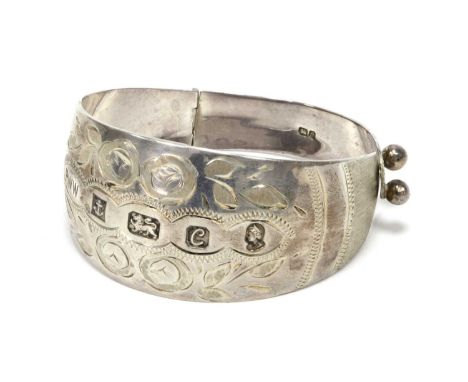 A Hallmarked Silver Jubilee Hinged Bangle, BWW, Birmingham 1977, the wide tapered bangle with floral style decoration and fea