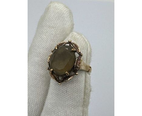A Vintage Stone Set Dress Ring, the oval stone four claw set to abstract style surround, between tapered band with spacer (fi