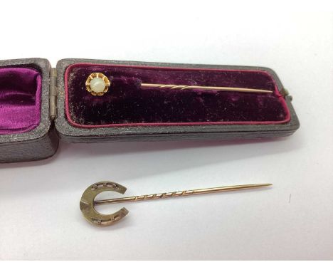 An Antique Horseshoe Stick Pin, together with an Edwardian style pearl set stick pin, the pearl claw set within flared rim se