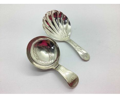 A Georgian Hallmarked Silver Caddy Spoon, London 1832, with shell bowl and flowerhead decoration to handle, with another Geor