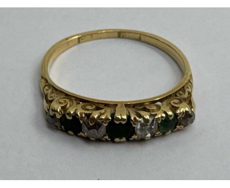  A Vintage Seven Stone Ring, the claw set stones alternately diamond set, within decorative scroll setting, to slim tapered b