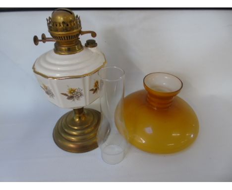 Brass and porcelain oil lamp with orange glass shade approx 23" tall