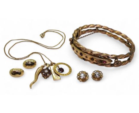 An af yellow metal vintage bangle, four 9ct gold pendants to include garnets and opal, horn of plenty and a retro ingot, and 