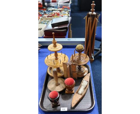 Treen sewing/knitting accessories, comprising a table-mounted wool winder, a smaller tabletop example, two bobbin stands, a c