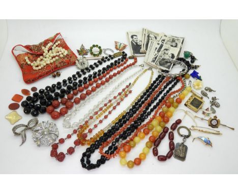 Collection of beads including cherry amber coloured, coral, glass and red jasper, together with unmounted pieces of carnelian