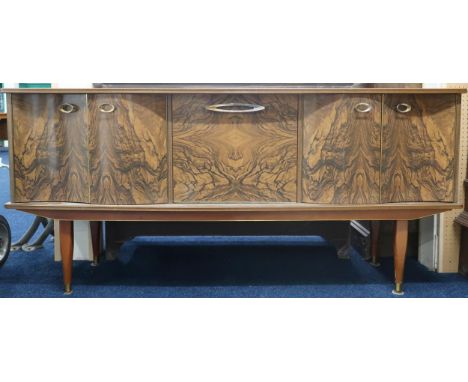 A mid 20th century Argosy Furniture sideboard with central fall front drinks compartment flanked by two pairs of cabinet door