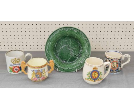 Four Royal commemorative porcelain cups, one Queen's Silver Jubilee by Burleigh, one by Laura Knight, one Paragon, one Wilkin