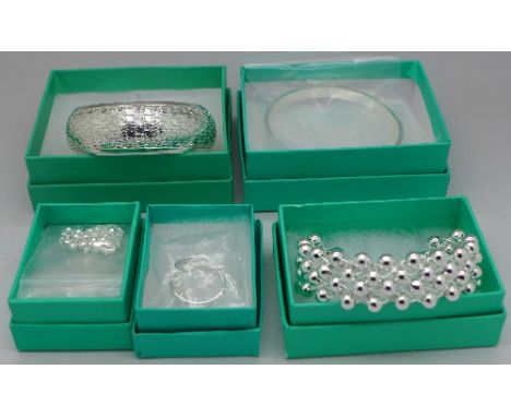 Three silver bangles, a ring and a necklace