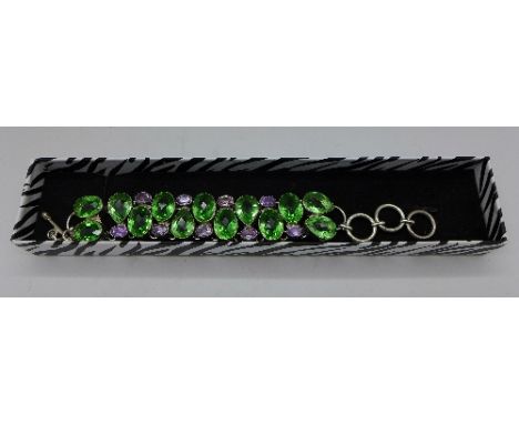 A silver, amethyst and green stone bracelet
