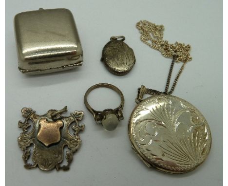 A plated sovereign holder, a silver locket and chain, a silver and moonstone ring, fob and locket