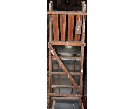 A vintage four tread folding step ladder