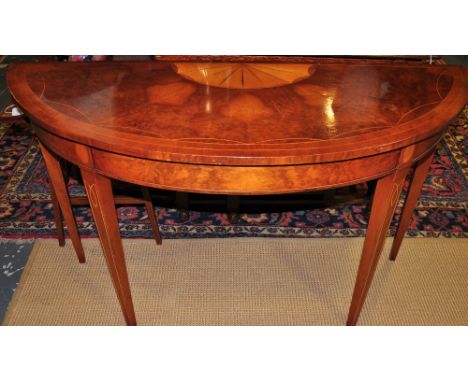 A George III style satin wood paterae inlaid bur walnut D shaped console table on square tapered legs, W:122cm