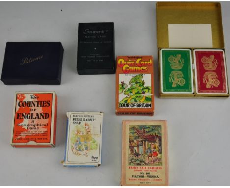 An assortment of 7 vintage packs of playing cards and other card games
