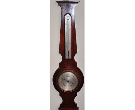 A 1920s aneroid wheel barometer combined thermometer with silvered dials together with a later oak desk barometer