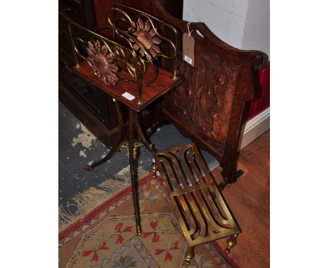 An embossed and incised copper Art Nouveau fire guard in an oak surround, together with a magazine rack