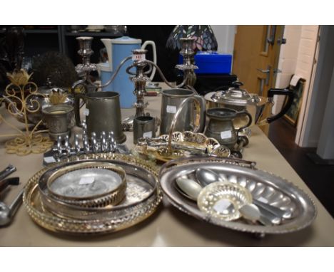 A mix of plated wares, pewter and similar amongst the lot there are candlestick holders, bowls, toast racks and more.
