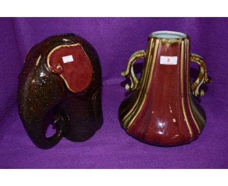 A ceramic elephant vase and similar heavy set squat vase in red and green glaze