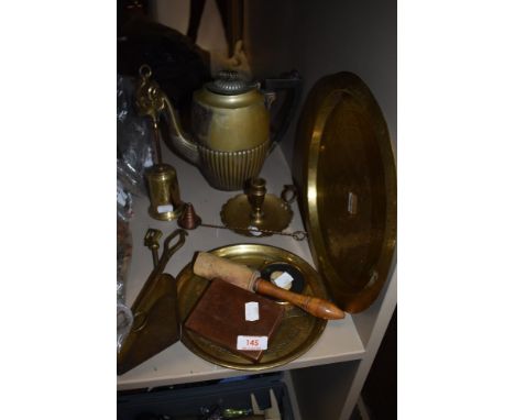 A mixed lot of brass, fire side utensils, two embossed platters a candlestick holder and more, also included if a copper face