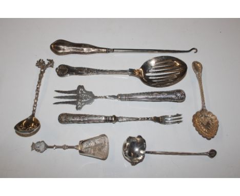 A silver handled pickle fork; a silver handled button hook and various spoons 