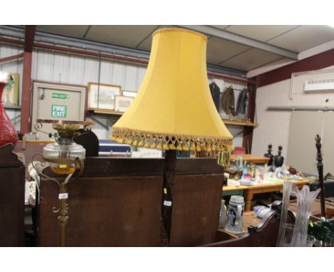 An Oriental carved standard lamp