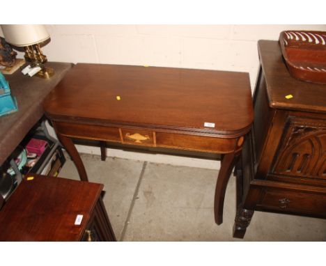 A mahogany and satin wood cross banded fold over card table 