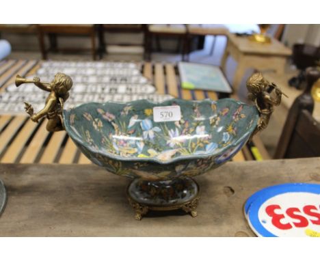 A bronzed and porcelain cherub decorated bowl