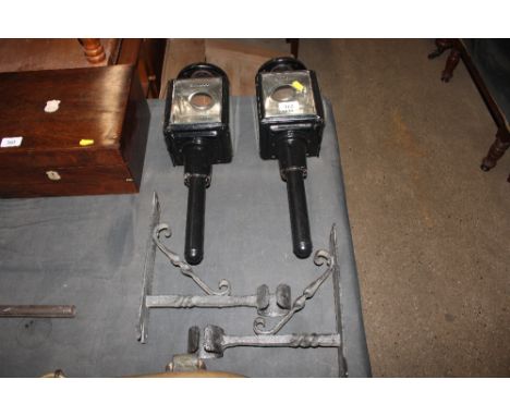 A pair of carriage lamp lanterns with metal wall mounting brackets 