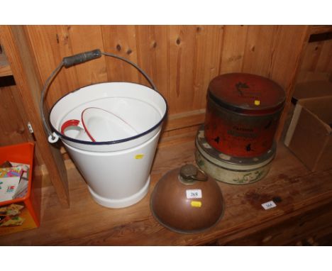 A vintage enamel pail,; chamber pot; copper hot water bottle; and two old confectionary tins
