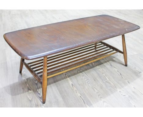An Ercol dark elm and beech coffee table, lower spindle tier and spindle legs, length 195cm, depth 46cm & height 37cm. 