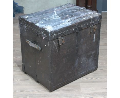 A 19th Century black canvas, metal and wood bound vintage steamer trunk by J Burton & Co with leather carry handles either si