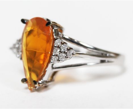 A 9ct white gold fire opal and diamond ring, the oval cut central stone approx. 1.59 carats, diamond set shoulders, gross wt.