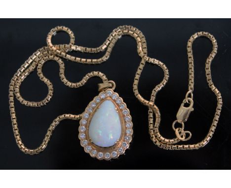 An opal and diamond pear drop pendant, the central pear shaped stone approx. 15.80 carats, surround by 25 round brilliant cut