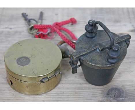 A brass cased night watchman's clock "Excelsior", diam. 9cm, together with set of graduated cast metal cups.