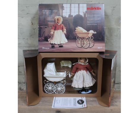 A Marklin doll and pram 1611, boxed with certificate. 